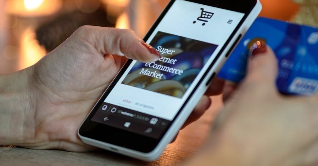 Person Using Black And White Smartphone and Holding Blue Card